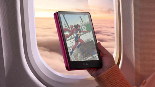 Hand holding a Kindle Colorsoft displaying a colorful comic scene, viewed from an airplane window.